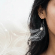 Woman wearing sterling silver bird nest earrings