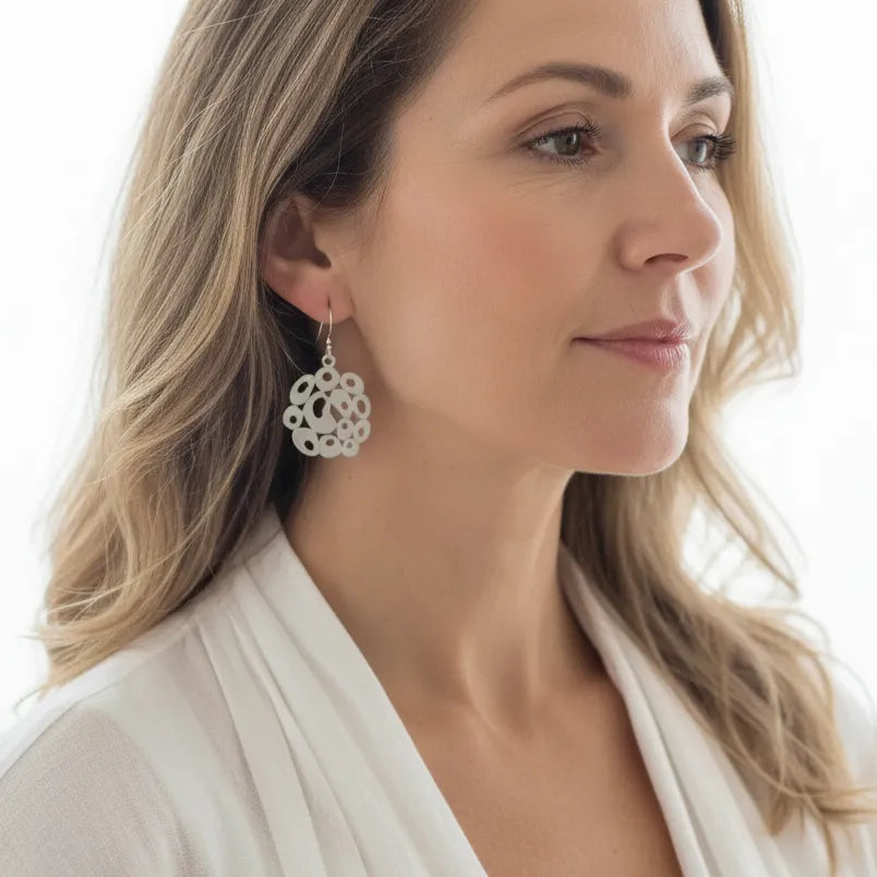 Woman wearing silver bubble drop earrings