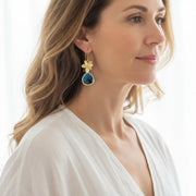 Capri blue single orchid drop earrings in gold plate, shown worn
