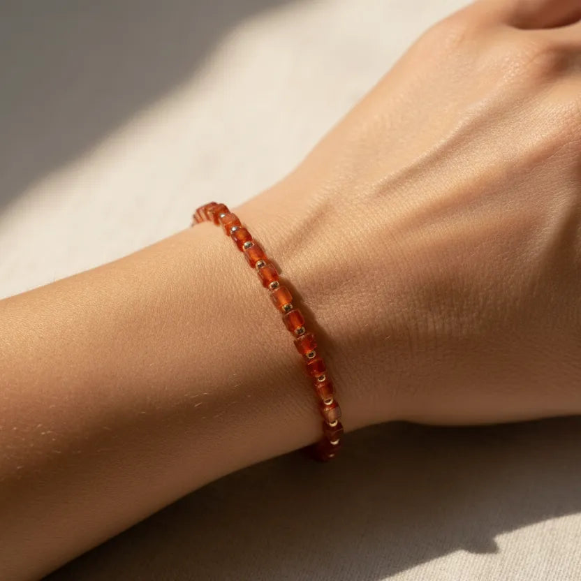 Woman wearing a carnelian beaded bracelet, sacral chakra jewelry