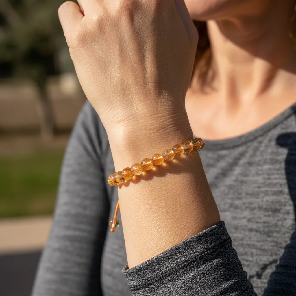 Person wearing a beaded bracelet on an outdoor background
