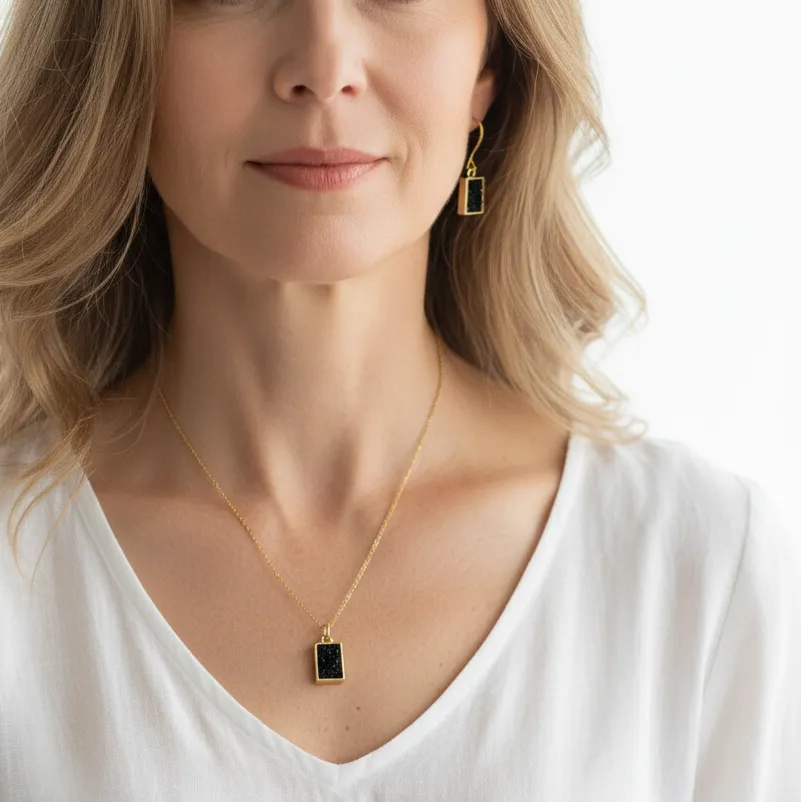 Woman wearing a black agate crystal necklace and earring set