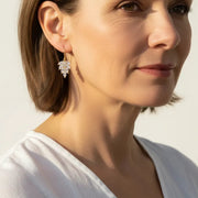 Woman wearing crystal leaf drop earrings