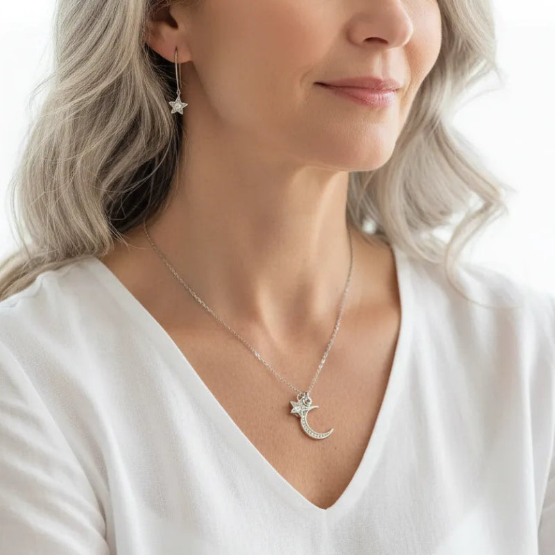 Woman wearing a silver crystal and star jewelry set, celestial jewelry