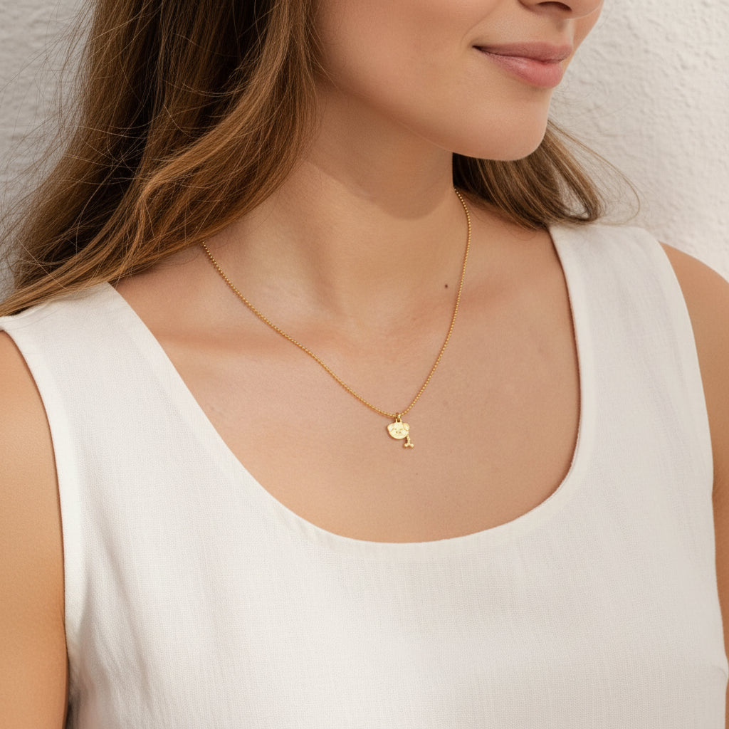 Woman wearing a gold dog bone medallion necklace — Crystals & Paws rescue jewellery for loyalty