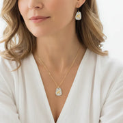 Woman wearing a dragonfly necklace with matching earrings, spirit animal jewelry