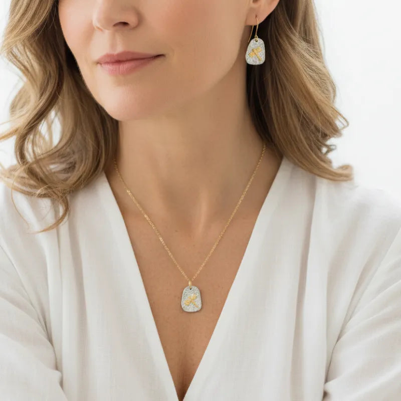 Woman wearing a dragonfly necklace with matching earrings, spirit animal jewelry