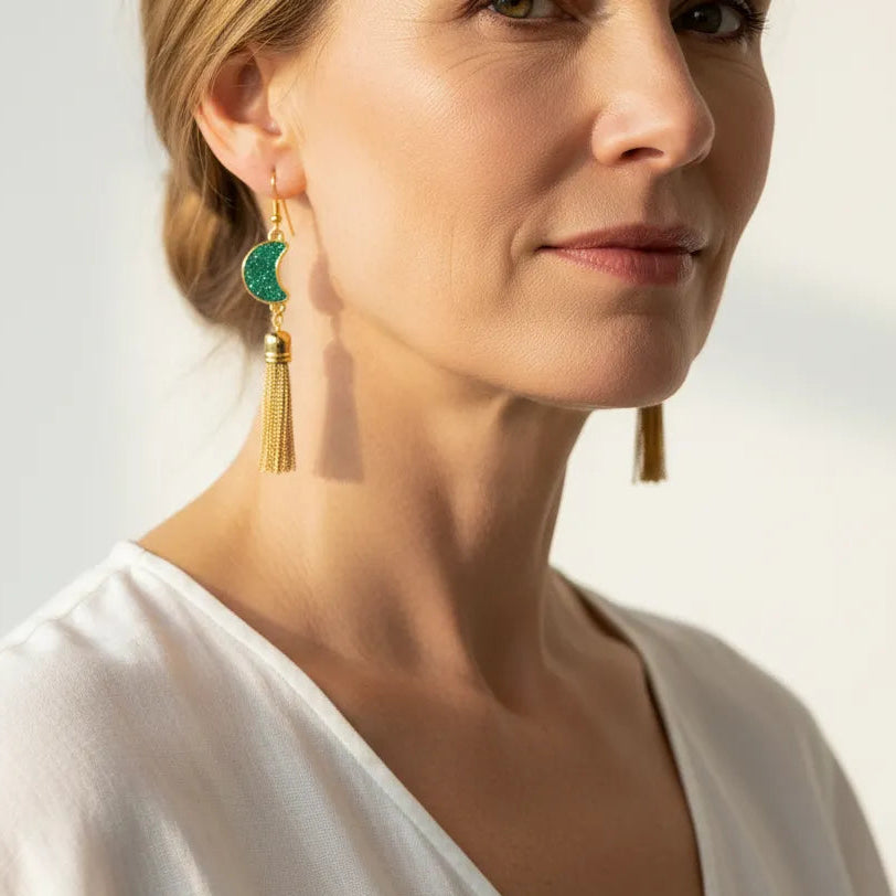 Woman wearing green druzy crescent moon earrings