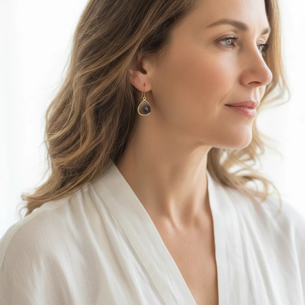 Woman wearing Dusk Elegant twilight glass drop earrings in gold