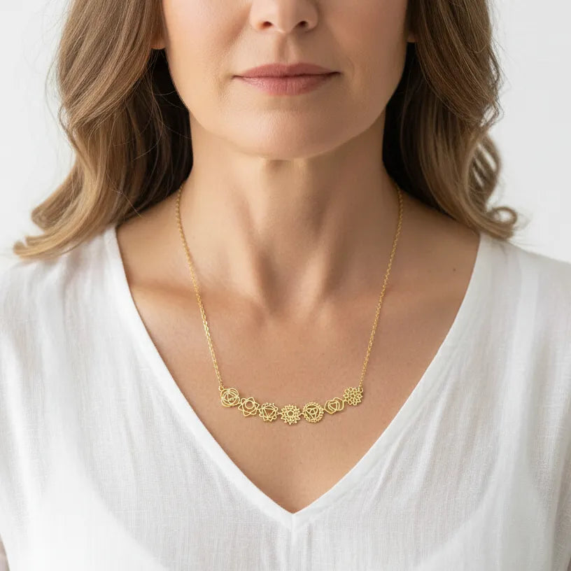 Woman wearing a gold seven chakra horizontal bar necklace, waterproof chakra jewelry