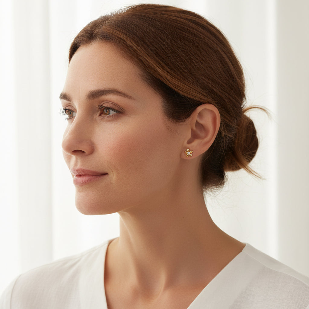 Woman wearing 18K PVD gold flower stud earrings