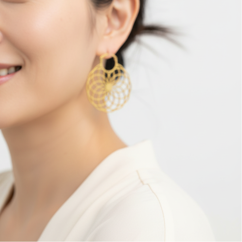 Woman wearing gold flower of life earrings — sacred geometry jewelry for balance and unity
