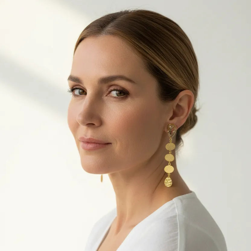 Woman wearing gold rutilated quartz statement drop earrings