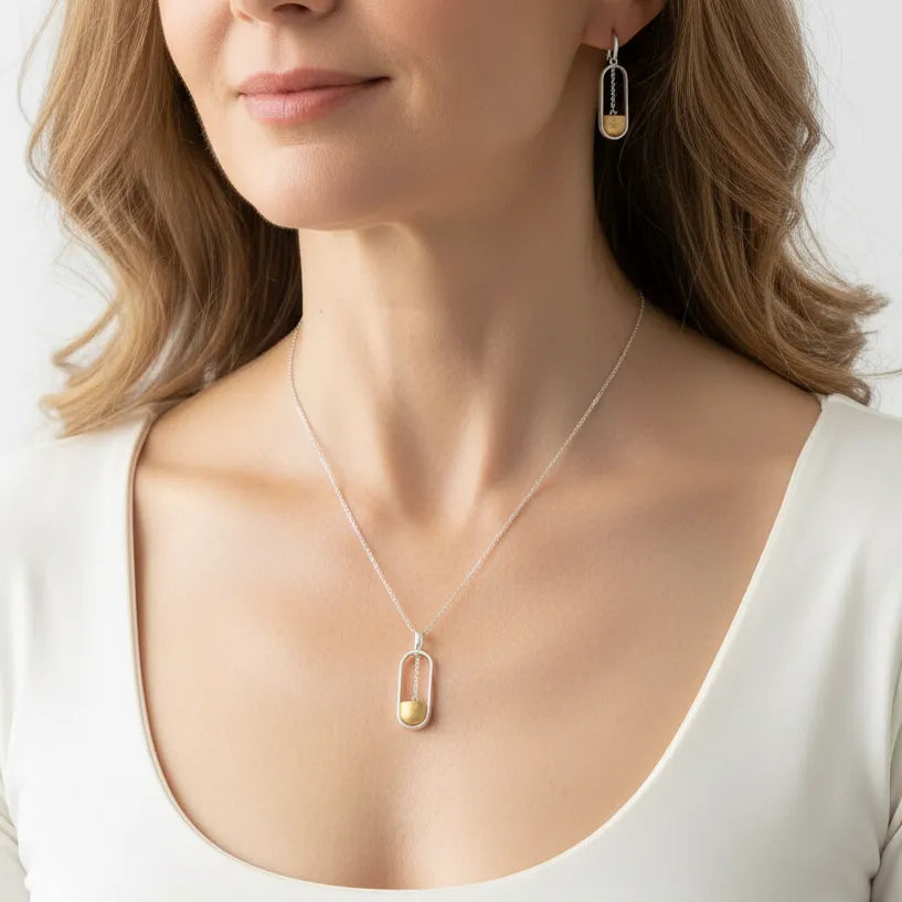 Woman wearing a good luck necklace with matching earrings
