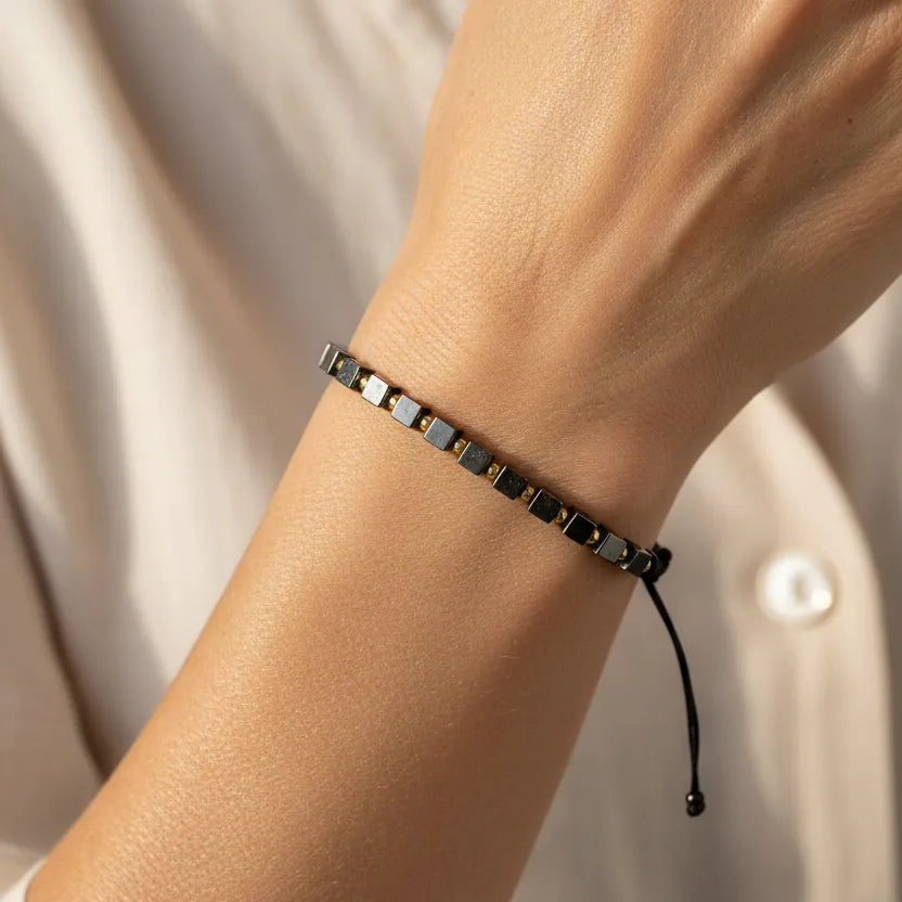 Woman wearing a hematite beaded bracelet, root chakra jewelry