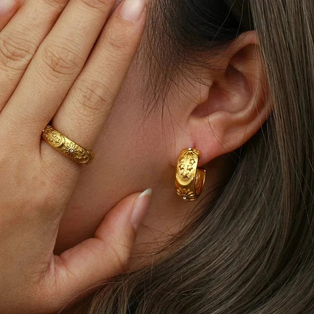 Woman wearing gold moon stud earrings and ring — celestial jewelry for guidance