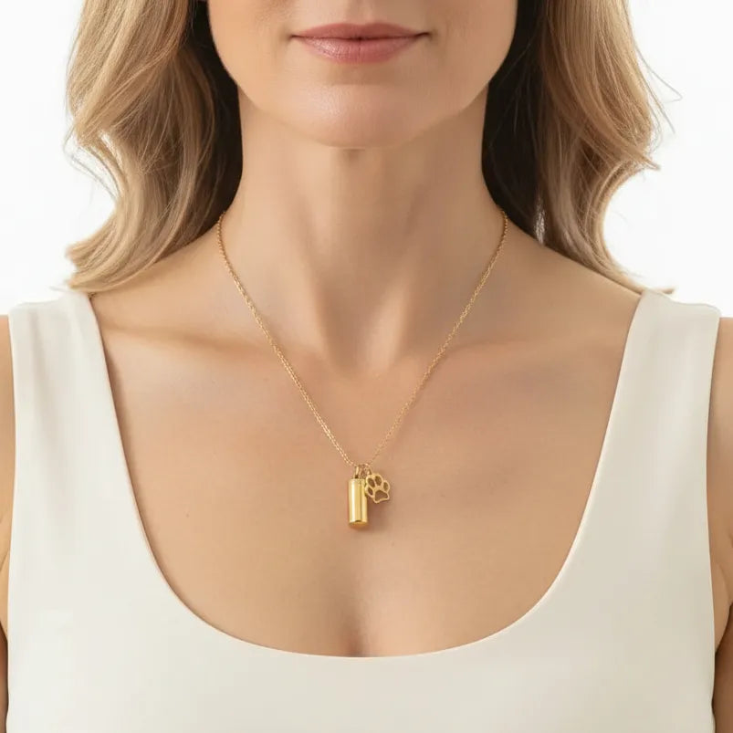 Woman wearing a gold paw print urn necklace, pet memorial jewelry