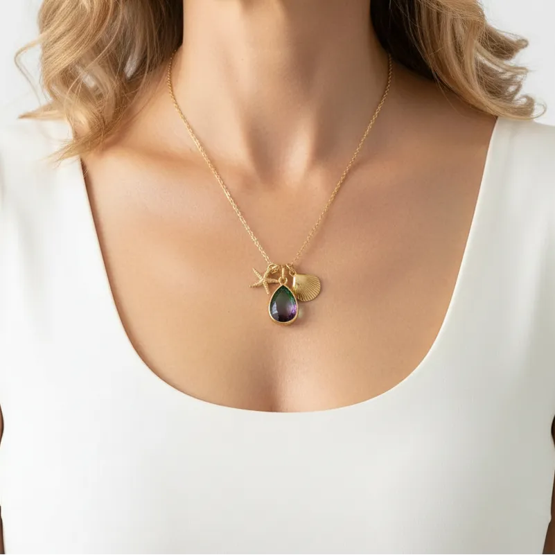 Woman wearing a peacock aura shell and starfish necklace with stone detail