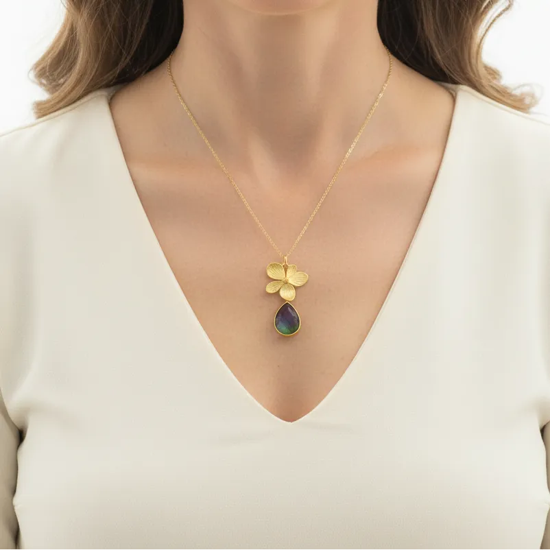 Woman wearing a peacock orchid necklace with stone detail