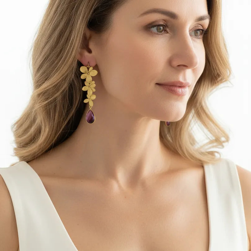 Woman wearing pink triple orchid drop earrings