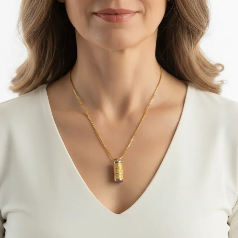 Woman wearing a prayer wheel necklace, spiritual symbol jewelry