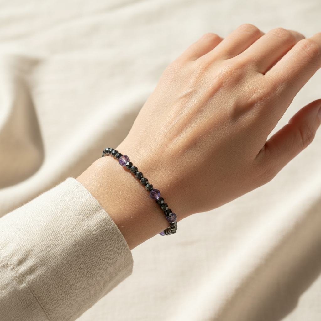Woman wearing the pyrite and Swarovski crystal bracelet stacked on her wrist for everyday sparkle