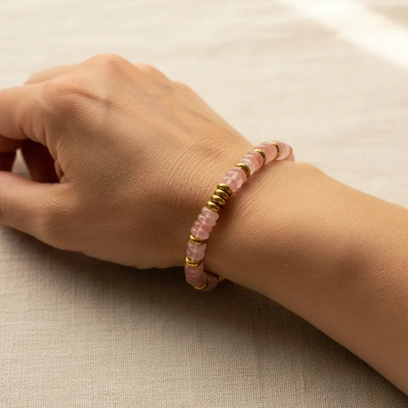 Woman wearing a rose quartz beaded bracelet, heart chakra jewelry