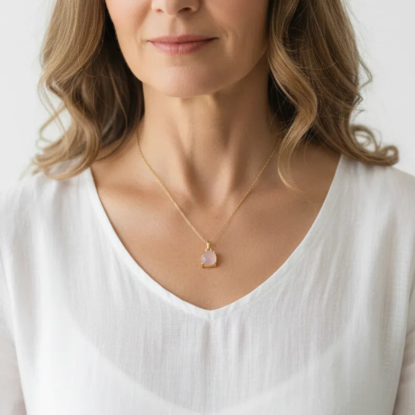 Woman wearing a rose quartz necklace, heart chakra jewelry