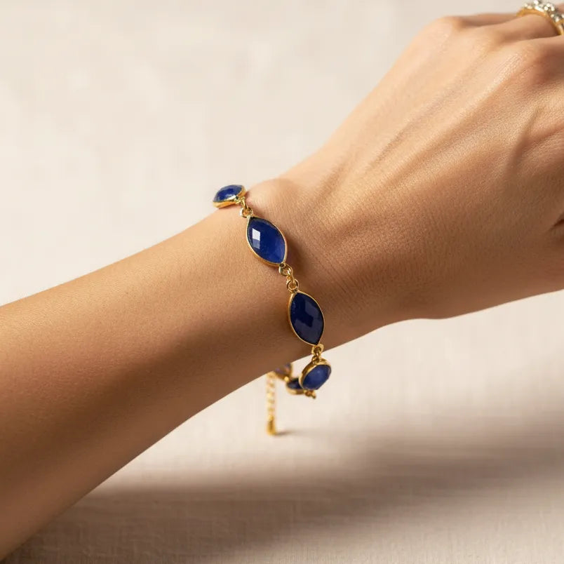 Woman wearing a sapphire beaded bracelet, September birthstone jewelry