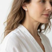Woman wearing sterling silver hummingbird drop earrings