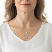 Woman wearing a sterling silver hummingbird pendant necklace, spirit animal jewelry