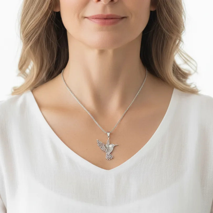 Woman wearing a sterling silver hummingbird pendant necklace, spirit animal jewelry