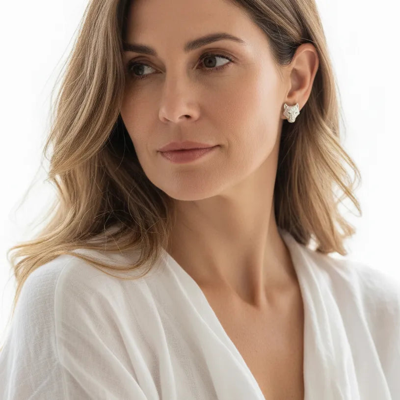 Woman wearing sterling silver wolf stud earrings, spirit animal jewelry