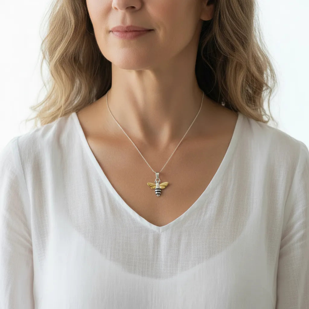 Woman wearing a sterling silver bee pendant necklace