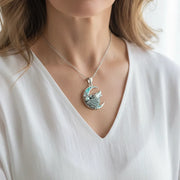 Woman wearing a sterling silver wolf chain necklace, spirit animal jewelry