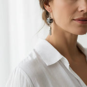 Woman wearing boho tassel bead earrings in silver, Kashmiri charm jewelry