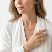 Woman wearing a third eye necklace with a matching ring, third eye chakra jewelry