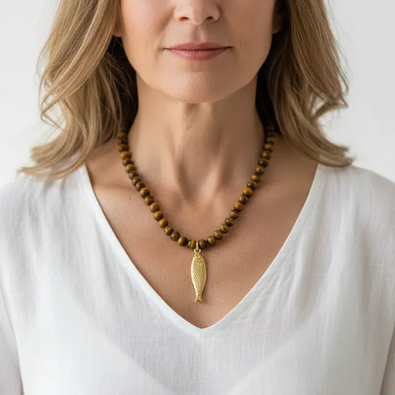 Woman wearing a tiger eye fish pendant necklace