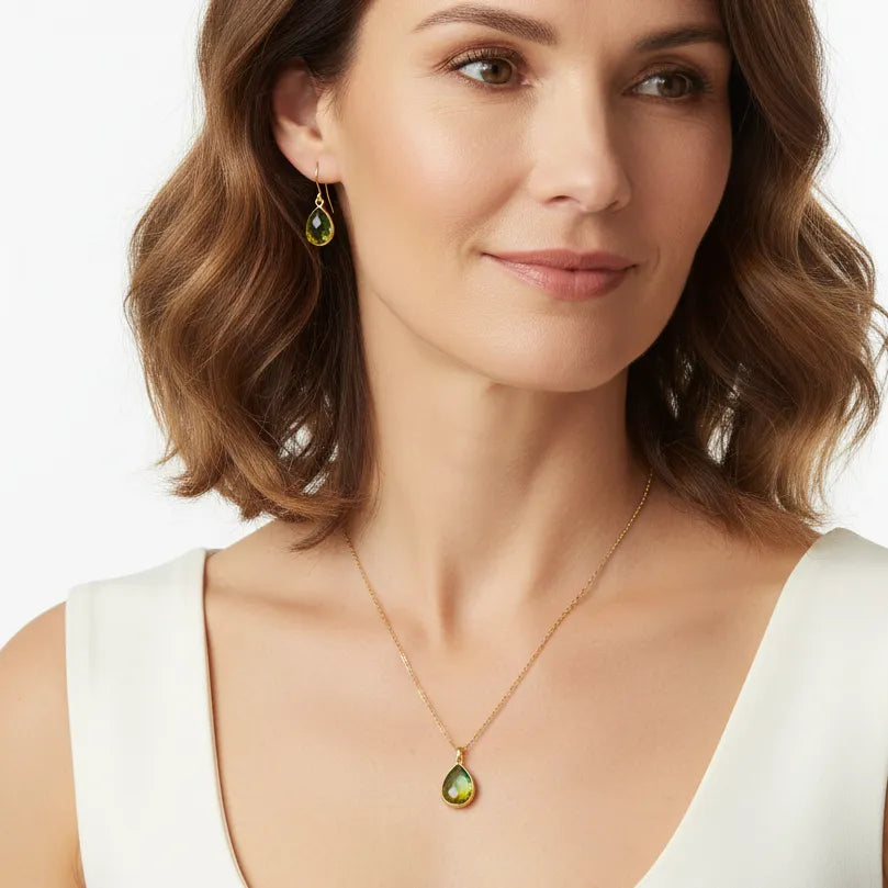 Woman wearing a Tropical Aura drop necklace and earring set with stone detail