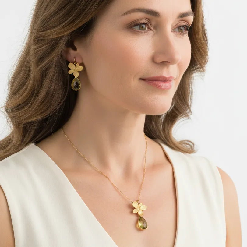 Woman wearing a Tropical Aura single orchid necklace with matching earrings
