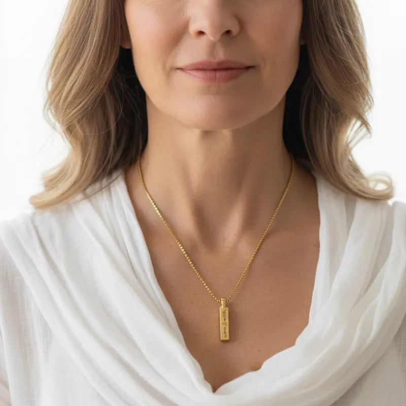 Woman wearing a vial necklace that opens, keepsake jewelry