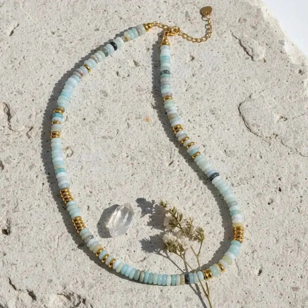 Necklace with multicolored beads and gold accents on a white background