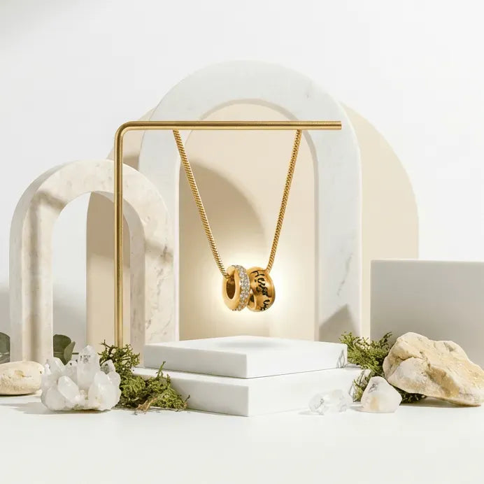 Gold necklace in a gold box on a white background with decorative elements