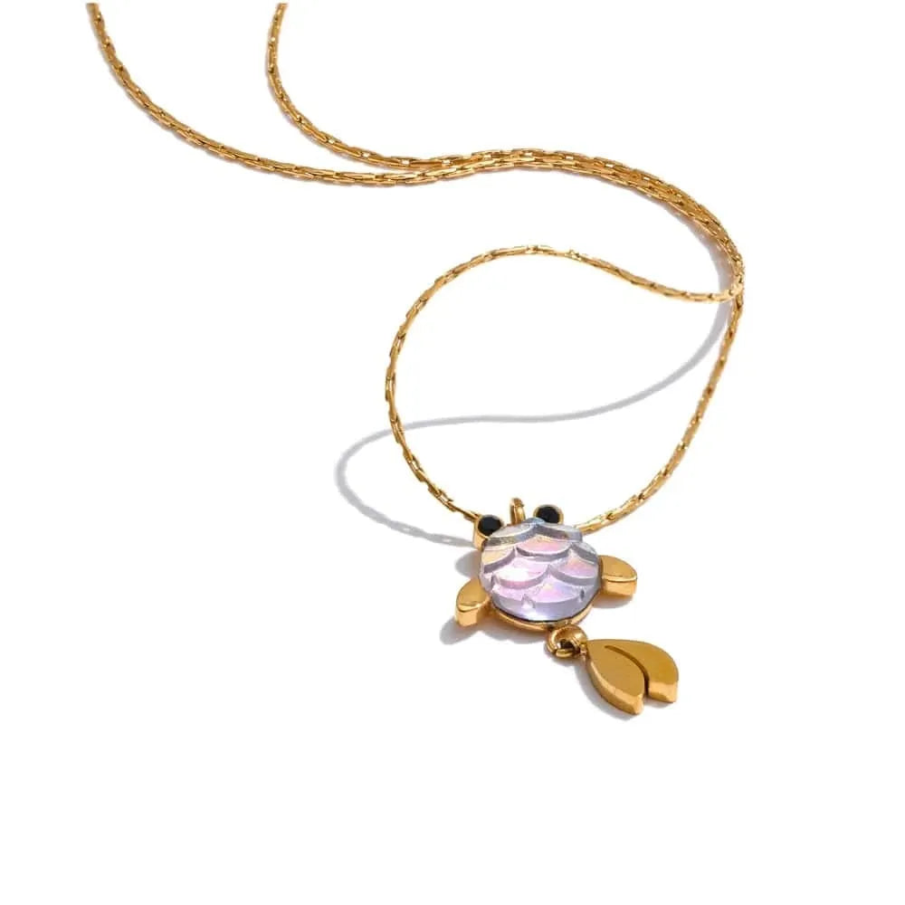 Gold necklace with a shell pendant on a white background