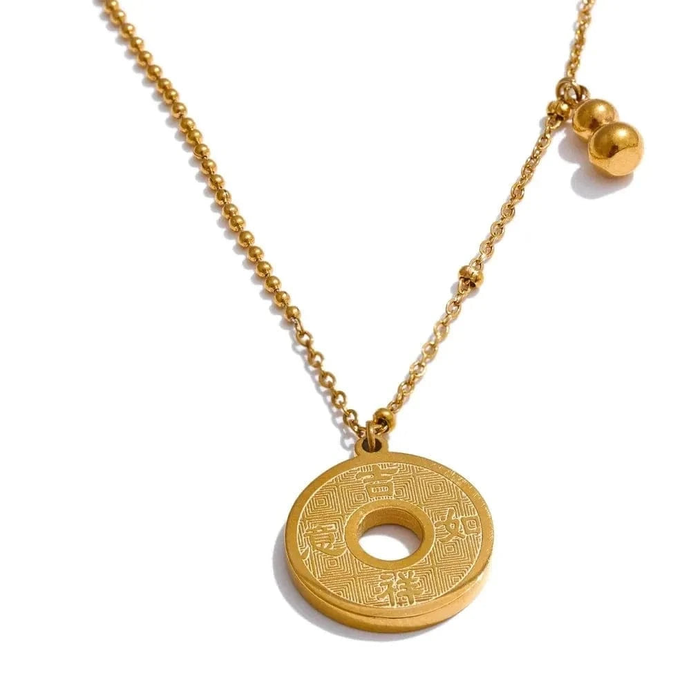 Gold necklace with a round pendant on a white background