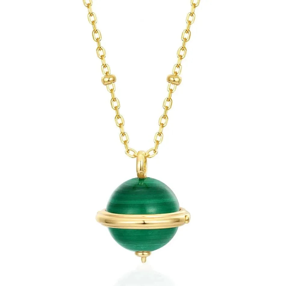 Gold necklace with a green pendant on a white background