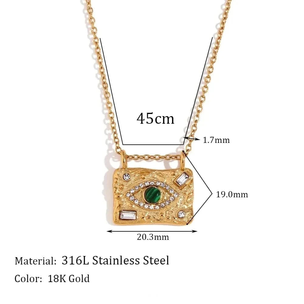 Gold necklace with green gemstone pendant and measurements on a white background