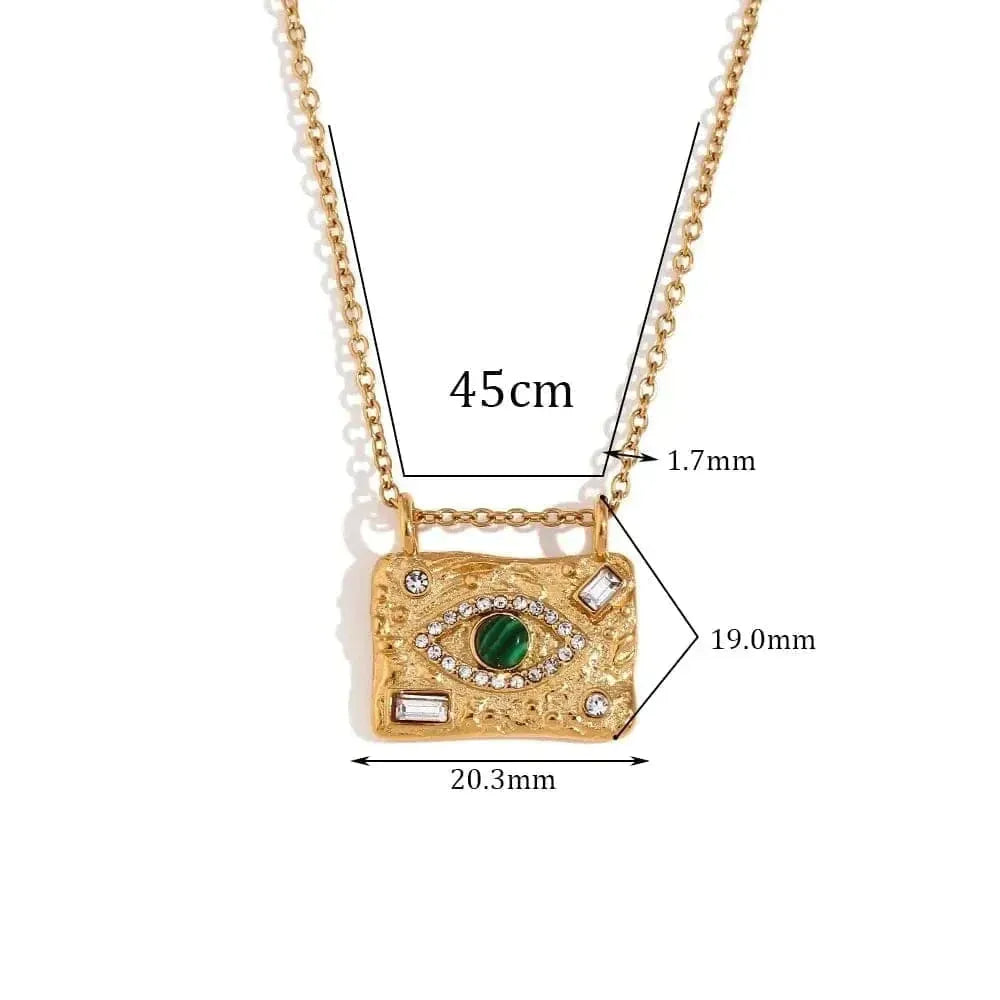 Gold necklace with green gemstone pendant and measurements on a white background