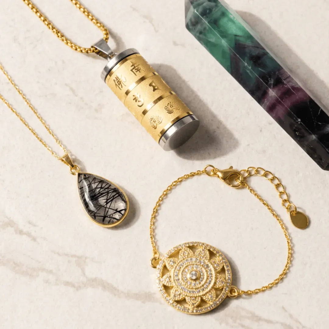 Gold necklace and bracelet with a crystal on a textured surface