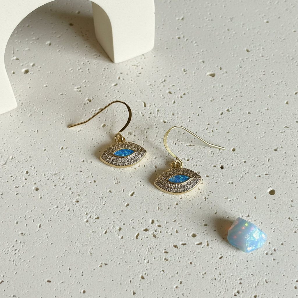 Close up of gold plated marquise evil eye earrings showing the faux opal centre stone
